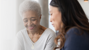 Woman meeting with her Health Navigator who helps arrange her appointments.