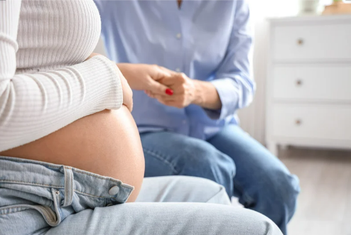 A Maternity Health Navigator with an expectant mother at a medical appointment.